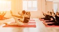 Group of happy middle aged women with fitness instructor, stretching in the gym before pilates, on a yoga mat near the Royalty Free Stock Photo