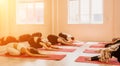 Group of happy middle aged women with fitness instructor, stretching in the gym before pilates, on a yoga mat near the Royalty Free Stock Photo