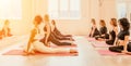 Group of happy middle aged women with fitness instructor, stretching in the gym before pilates, on a yoga mat near the Royalty Free Stock Photo