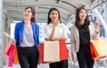 Group of young women carrying shopping bags while walking along the street. Happy Life and Shopping Concepts Royalty Free Stock Photo