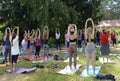 Group of young women doing morning exercises at a city park