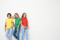 Group of young women in jeans and colorful t-shirts Royalty Free Stock Photo