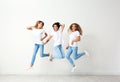 Group of young women in jeans jumping Royalty Free Stock Photo