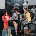 group of young women with shopping bags drinking coffee Royalty Free Stock Photo