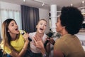 Young women spend free time in karaoke sing and have fun together with friends at home