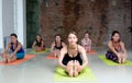 Group young women stretching and practices yoga