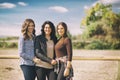 Group of young women, three friends enjoy in coutryside and laughing on a summer day, enjoying vacation