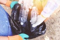 Group of young women volunteers helping to keep nature clean and picking up the garbage plastic bottle from park - Recycling and