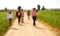 Group of young women walking on a field of wildflowers Royalty Free Stock Photo