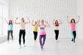 Group of young women in sportswear at dance fitness class in white fitness studio Royalty Free Stock Photo