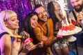 Group of younge people celebrating their friend's birthday. Royalty Free Stock Photo