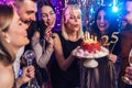 Group of younge people celebrating their friend's birthday. Royalty Free Stock Photo