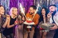 Group of younge people celebrating their friend's birthday. Royalty Free Stock Photo