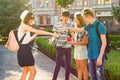 Group of youth is having fun, happy teenagers friends walking, talking enjoying day in the city.