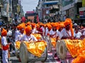 Group of youths beating huge traditional dhol collectively in Ganapati procession