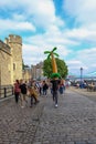 Group of youths walking along beside the Tower of London