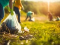 Groupe of friends collecting garbage in the park. Recycling concept