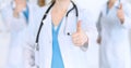 Groupe of medicine doctors show OK sign with thumb up close up. Success and high level service in health care, best