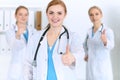 Groupe of medicine doctors show OK sign with thumb up. Success and high level service in health care, best treatment and