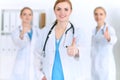 Groupe of medicine doctors show OK sign with thumb up. Success and high level service in health care, best treatment and