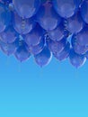 Grouped blue helium balloons with ribbons on blue sky