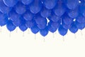 Grouped blue helium balloons with ribbons on white