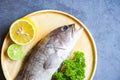 Grouper fish with lemon lime on wooden plate, Fresh raw seafood fish for cooked food Royalty Free Stock Photo