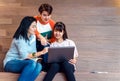 Groups of asian teenage students using laptop computer studying