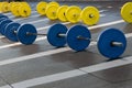Groups of Fitness Barbells with Blue and Yellow Disks