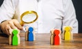 Groups of multicolored wooden people and businessman. The concept of market segmentation. Target audience, customer care. Market Royalty Free Stock Photo