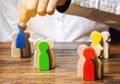 Groups of multicolored wooden people and businessman. The concept of market segmentation. Target audience, customer care. Market Royalty Free Stock Photo