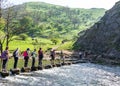 Groups of people crossing Dovedale River Walk Royalty Free Stock Photo