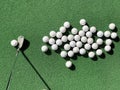 Groups of practice golf ball on artificial grass mat with one club iron