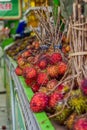 Groups of rambutan fruits displayed in market box