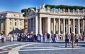 Groups of tourists enjoy the beauties of St. Peter`s Square in Vatican City Royalty Free Stock Photo