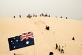 Tourists sliding sand board down the sand dunes in Port Stephen, Australia