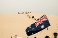 Tourists sliding sand board down the sand dunes in Port Stephen, Australia