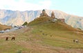 Groups of visitors climbing up to the Gergeti Trinity Church in Stepantsminda town, Kazbegi, Georgia