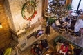 Groups of young people chatting at a vintage cafe talking and using smartphone during Christmas holiday top view.