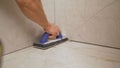 Grouting ceramic tiles. Grouting the floor with tiles Royalty Free Stock Photo