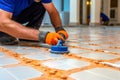 Grouting tiles with a rubber trowel. High quality photo Royalty Free Stock Photo