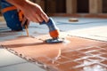 Grouting tiles with a rubber trowel. High quality photo Royalty Free Stock Photo