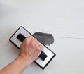 Grouting tiles with rubber trowel man hand Royalty Free Stock Photo