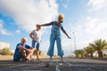 Grouyp of threee people of different ages playing together at the hopscotch on the asphalt of the street - seniors and adult woman Royalty Free Stock Photo