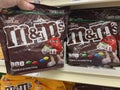 Grocery store hand selecting M&m\'s MMs Chocolate candy