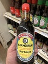 Retail grocery store hand holding Kikkoman soy sauce Royalty Free Stock Photo