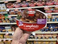 Retail store hand holding Hormel Completes meal