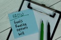 GROW - Goals Reality Options Will write on sticky note isolated on Wooden Table