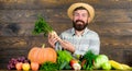 Grow organic crops. Farmer straw hat presenting fresh vegetables. Farmer with homegrown harvest. Farmer rustic villager Royalty Free Stock Photo