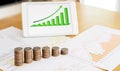 Grow up coins stack with business and finance graph screen on la Royalty Free Stock Photo